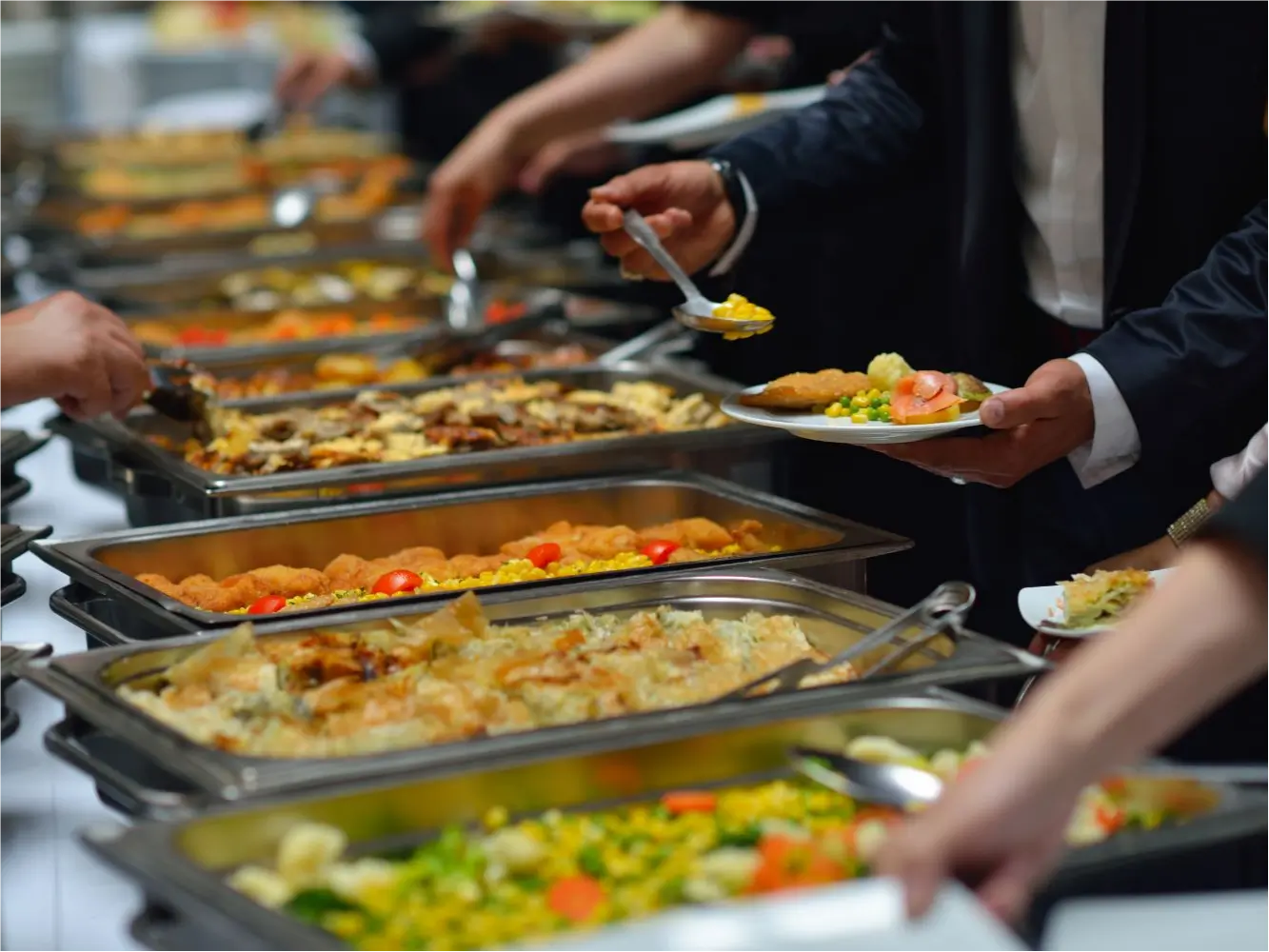 Guests serving themselves from a spread of assorted buffet dishes at Buffet City, a Buffet Restaurant in Tuscaloosa